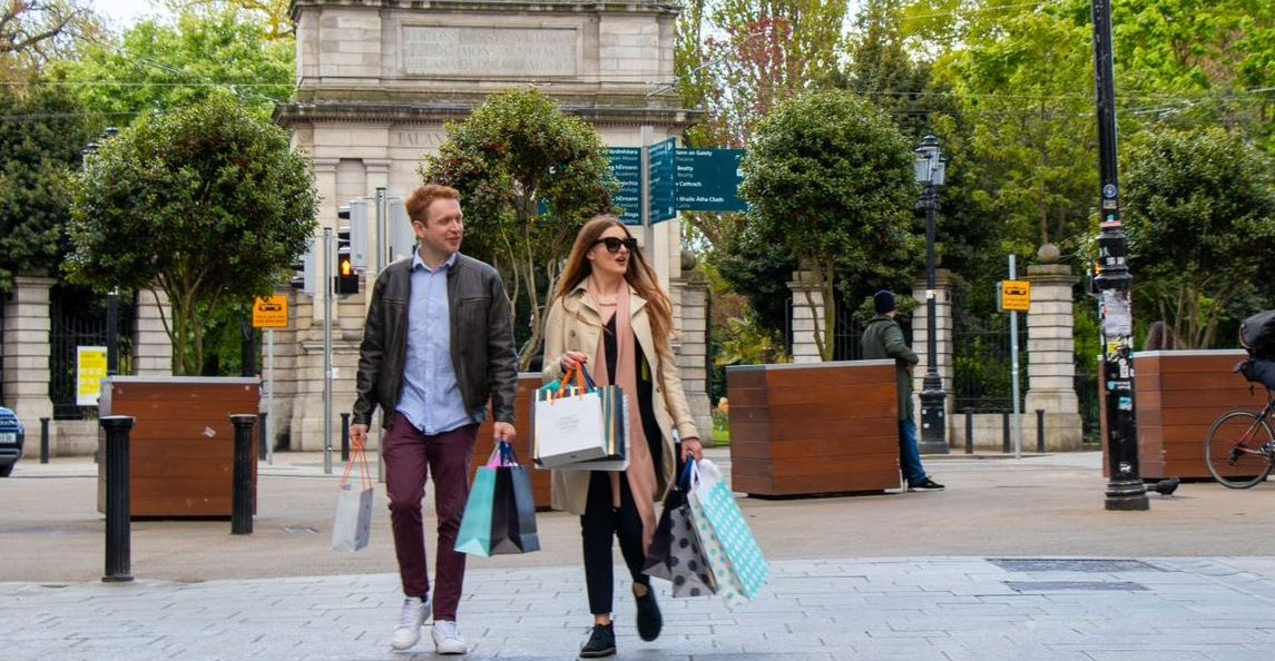 a group of people on a sidewalk