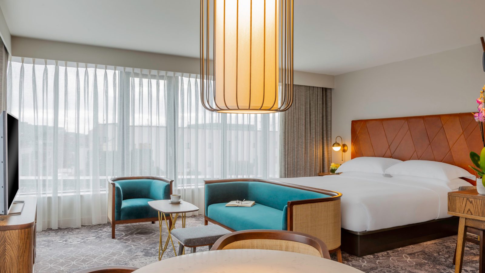 a bedroom with a bed and a chair in a room