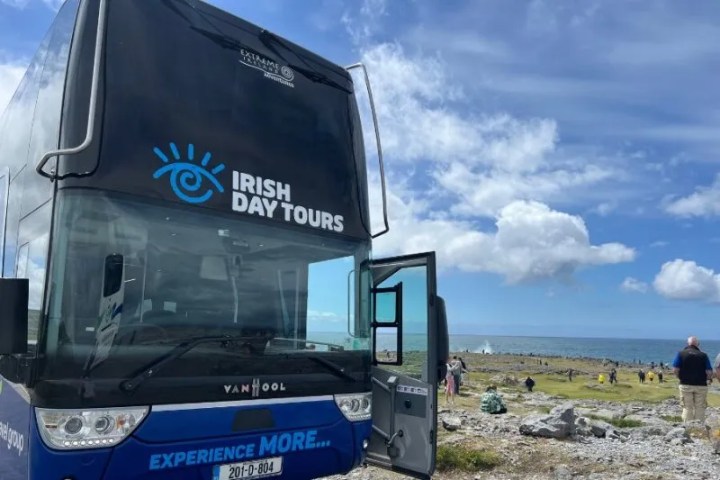 a bus parked in front of a truck