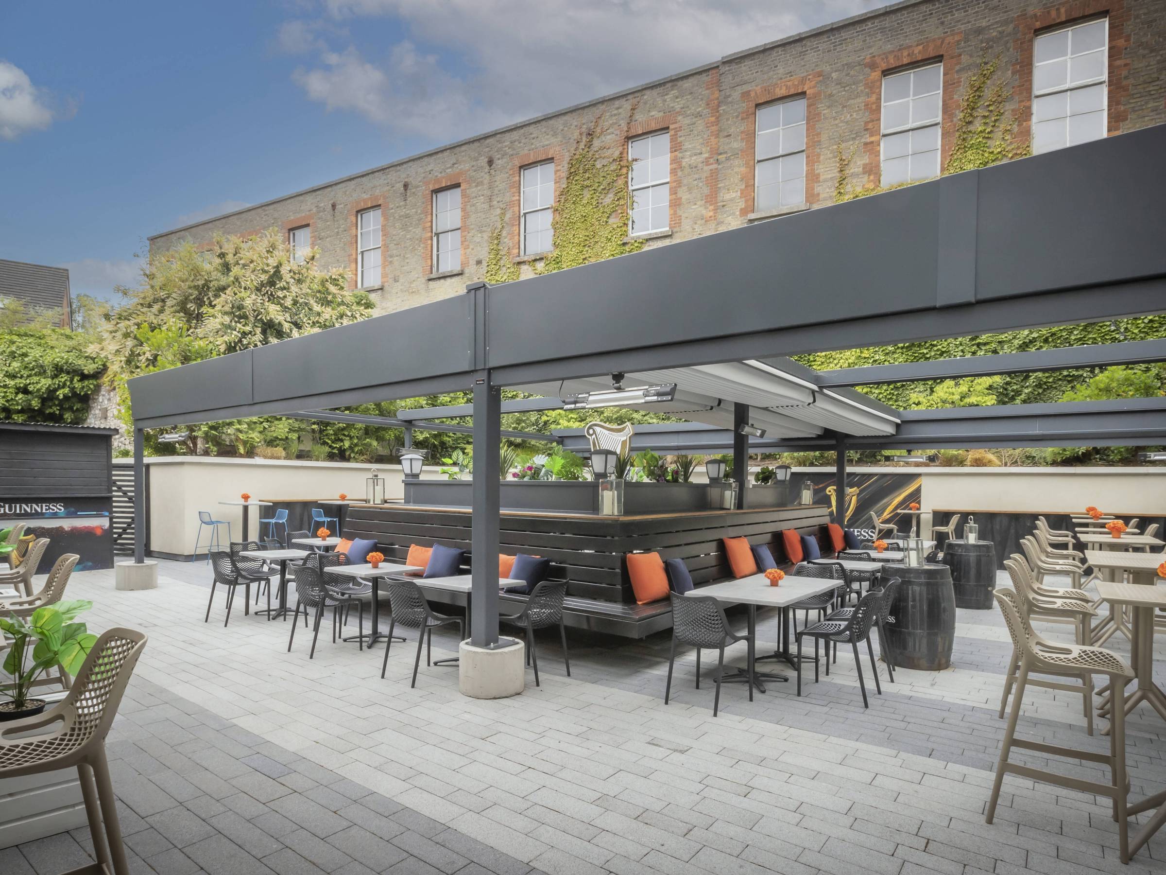 a group of people sitting at a table in front of a building